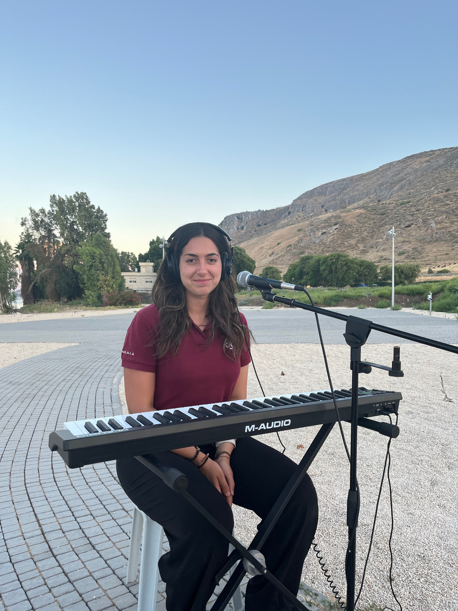 Mariana BE creating music at the keyboard in Magdala