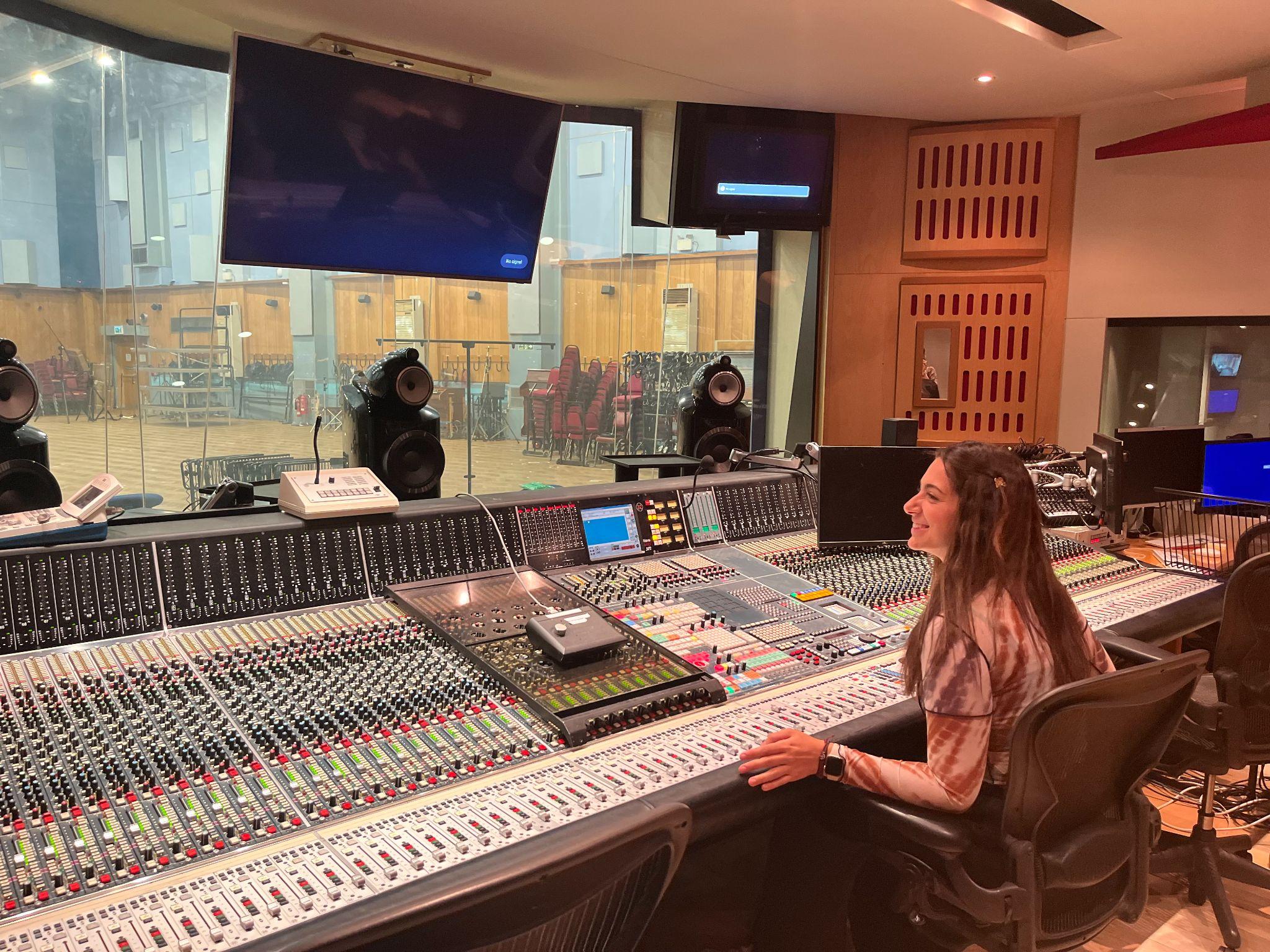 Mariana working at a recording studio console